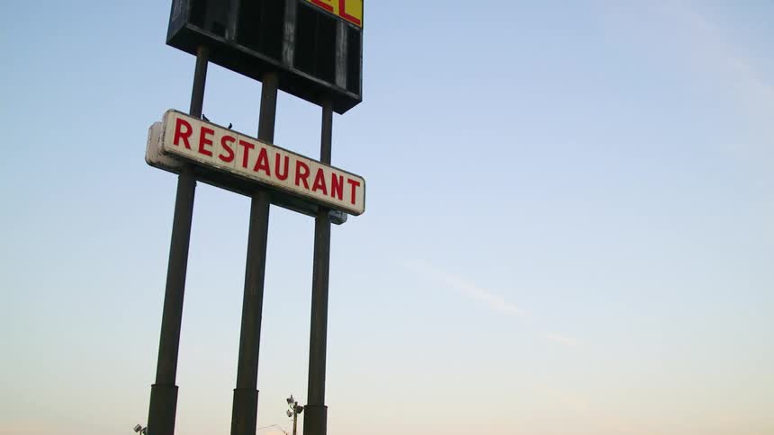 Sign outside advertising a restaurant and gas