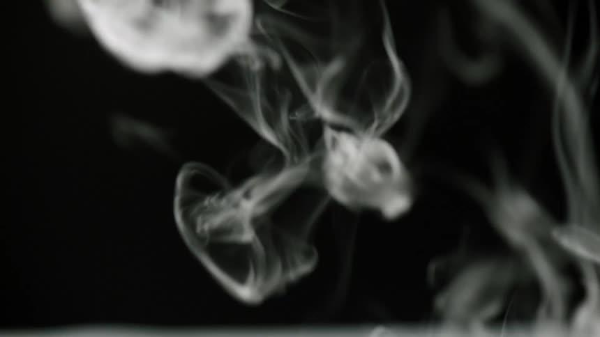White smoke billowing in front of a black background