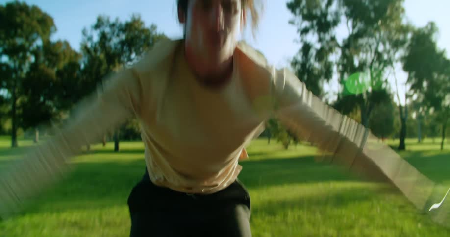 Man exercises on mat in lawn near trees