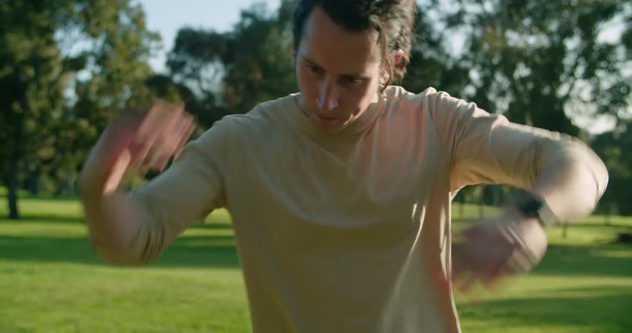 A man is stretching outdoors in spring