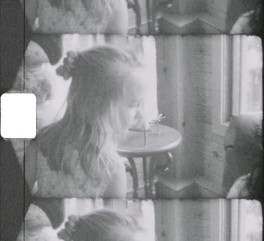 A girl looks over by the window