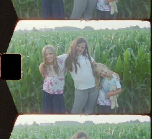 Vintage footage of young girls posing in front of corn stalks