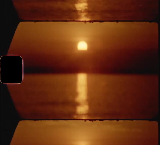 The sunset over a body of water with light reflecting with the sky and clouds above
