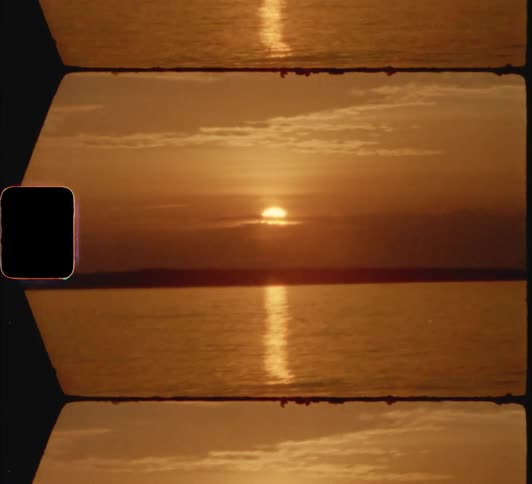 The sun setting over water rippling on a lake 8mm