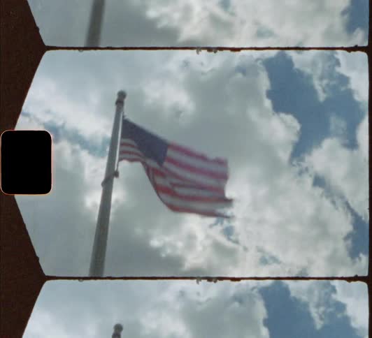 American flag flutters against the cloudy sky 8mm