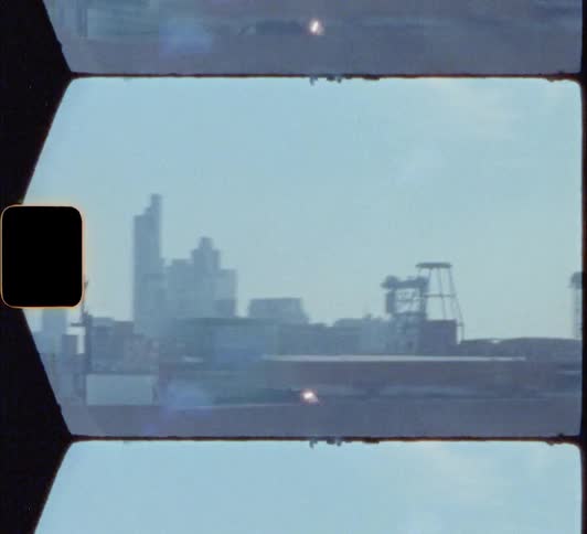 Shaky city skyline footage caught on film from a moving vehicle 8mm