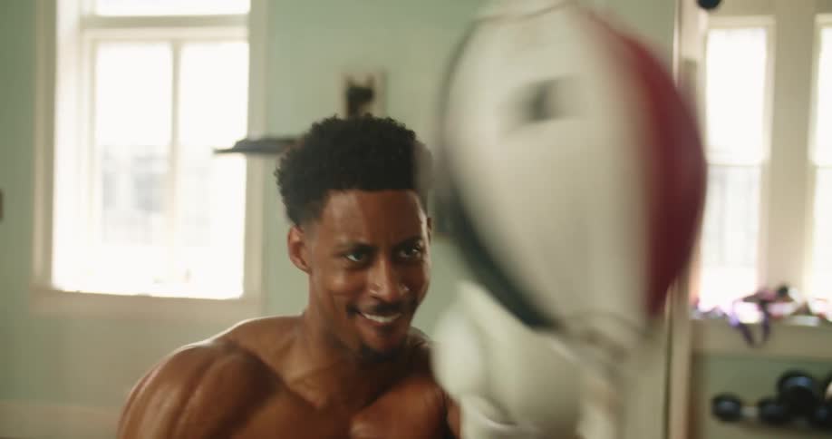A man punching a fast bag in a gym