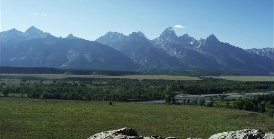 A large mountain range on a sunny summer day