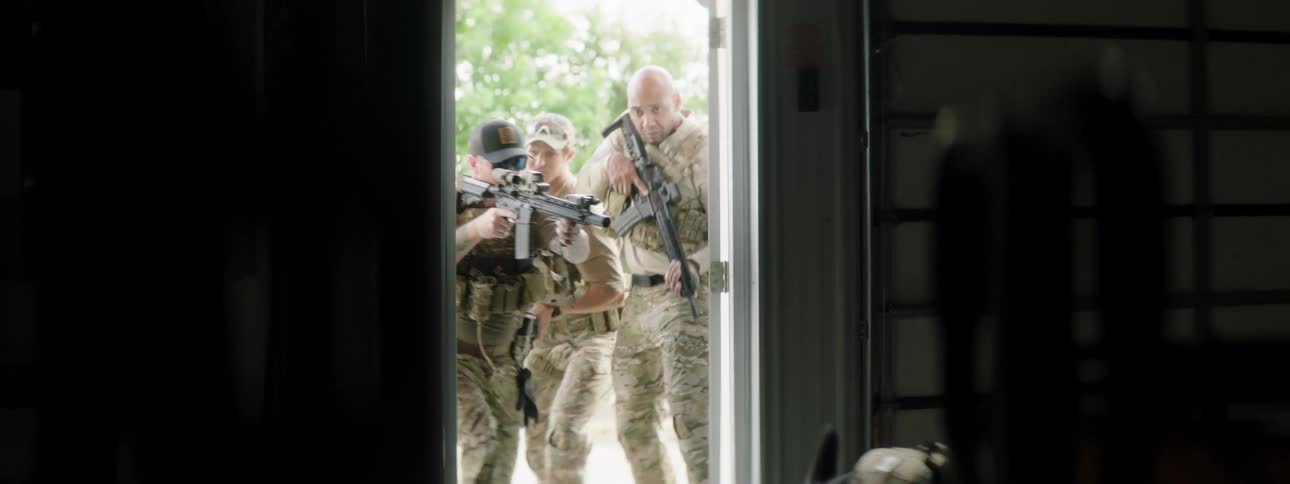 Soldiers enter the building with rifles