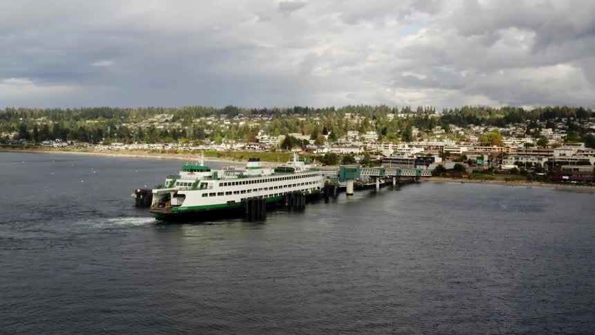 Ferry boat docked near oceanside town