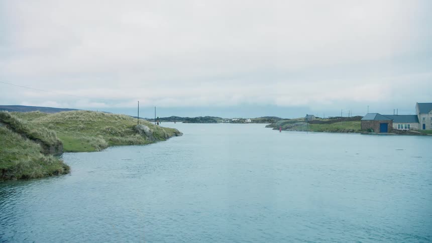 Water rippling on a rural lake with a building on the shore