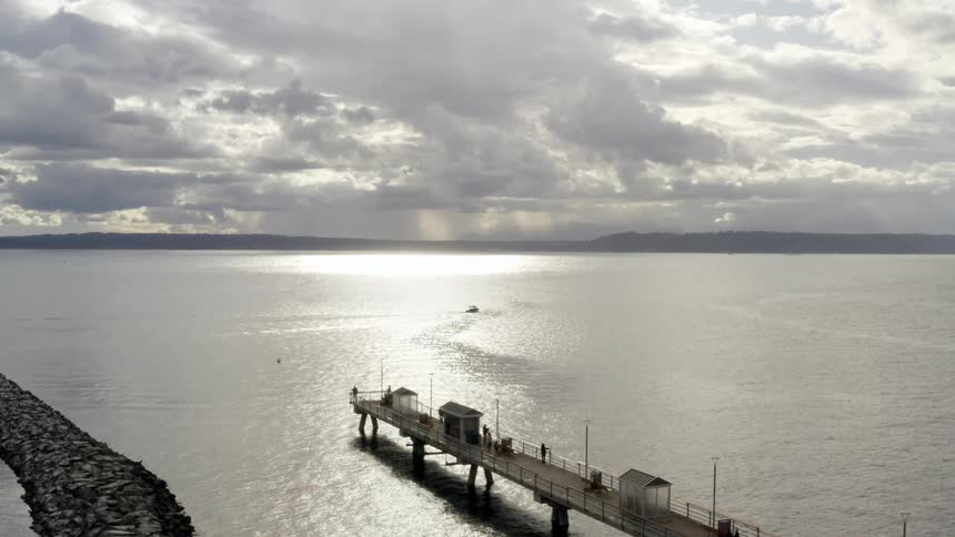 Aerial view of boats parked at a dock and a boat on the water