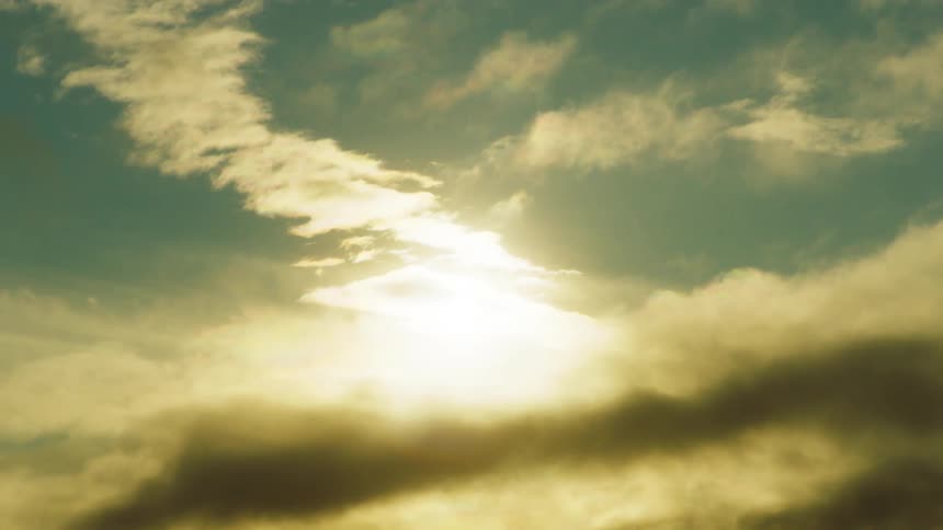 Clouds floating before the sun in the daytime sky