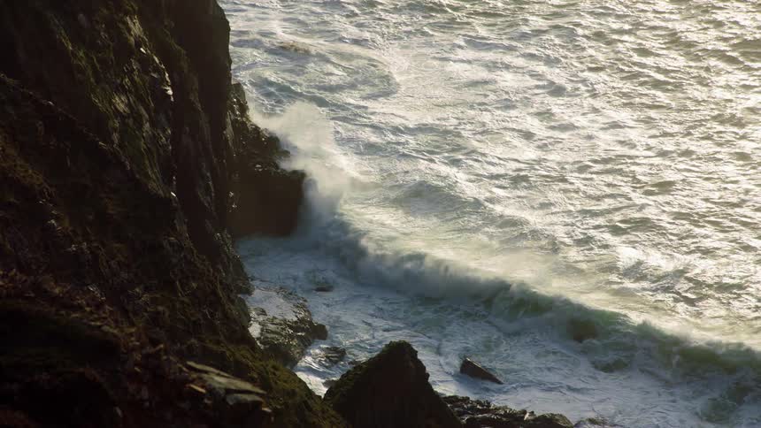 Heavy waves crash against the shore