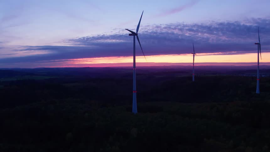 Aerial view of wind turbines in the wind farm at dusk