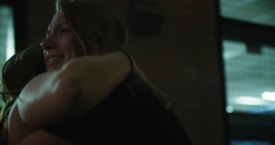 Women greet and hug each other