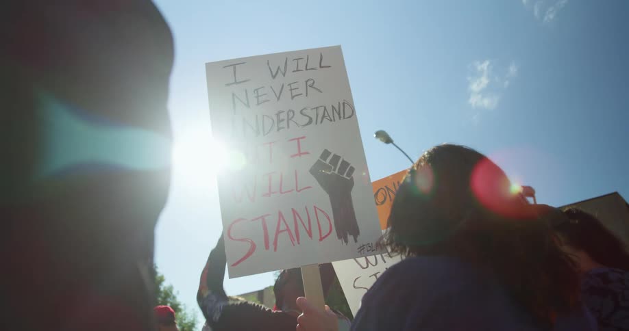 People holding signs at black lives matter demonstration