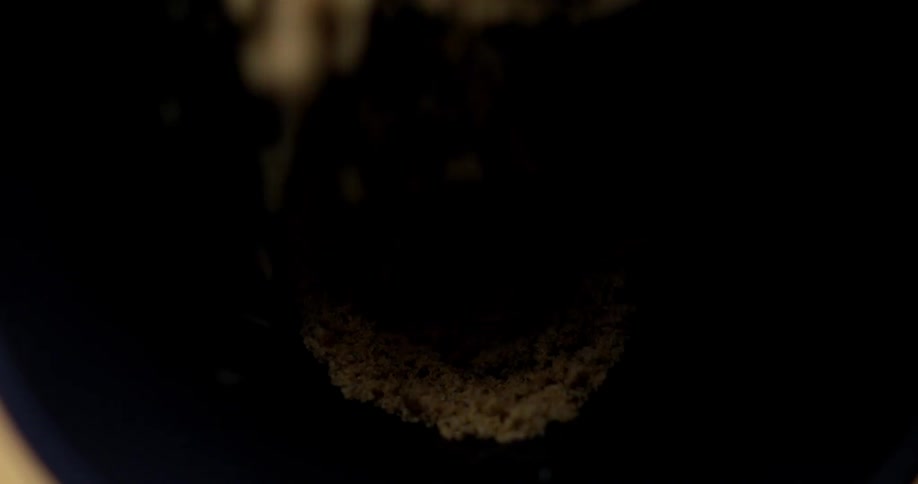 Sand falling into a black funnel