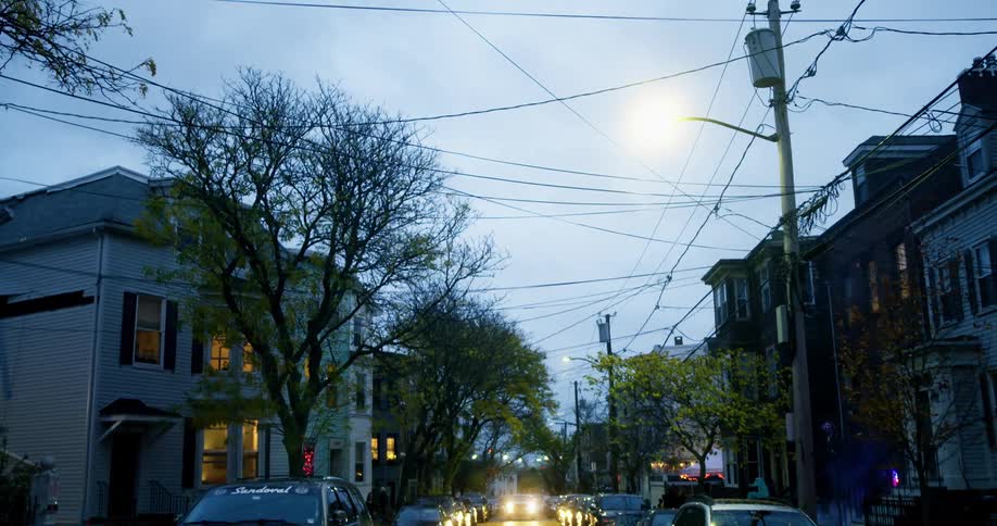 A cloudy sky over a city neighborhood in the evening