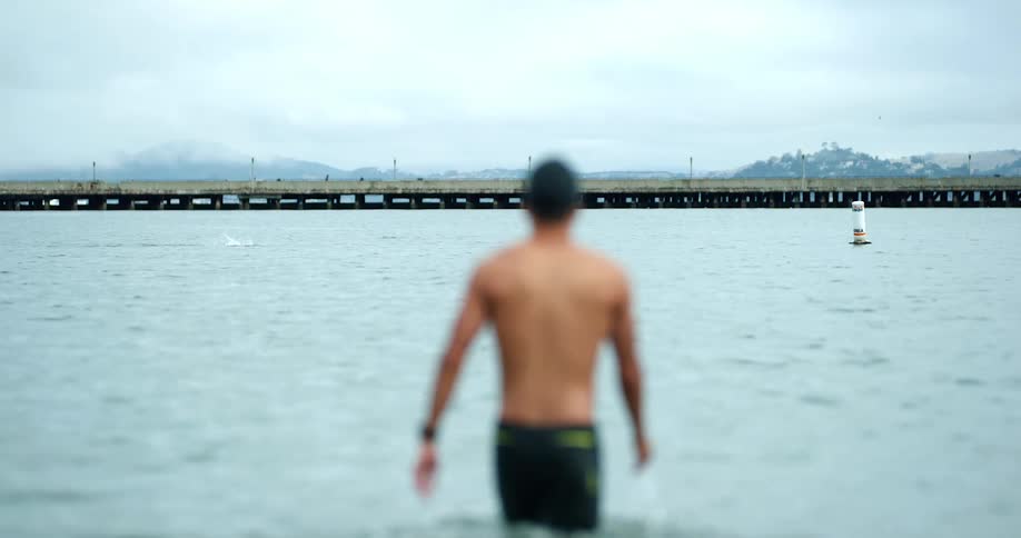 A man is swimming at the beach
