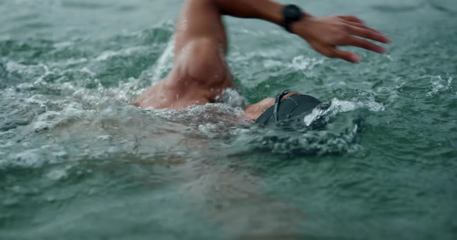 A man is swimming in the water