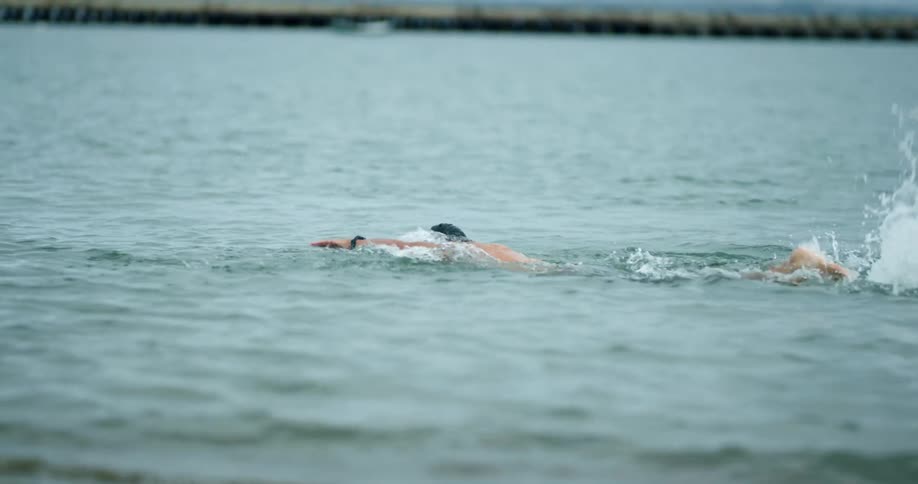 A man in a lake starts open water swimming