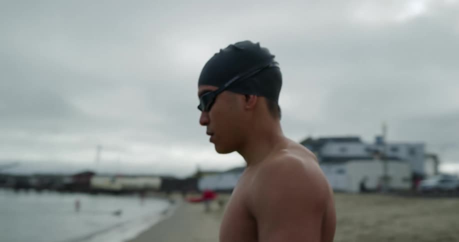 A male walking into the water