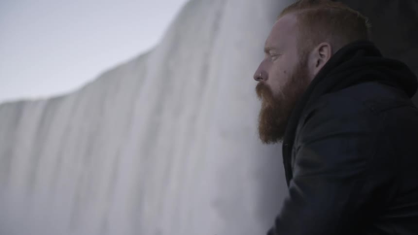 A man gazing into the distance near niagara falls