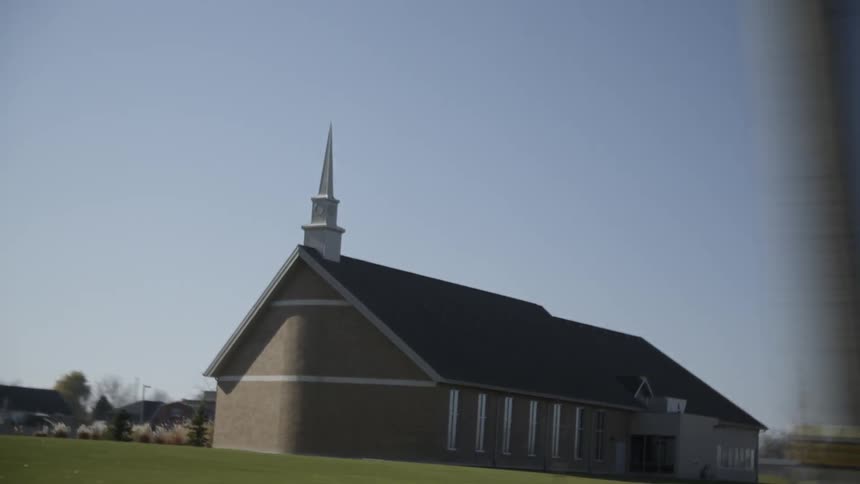 Traveling past a neighborhood church on sunny day