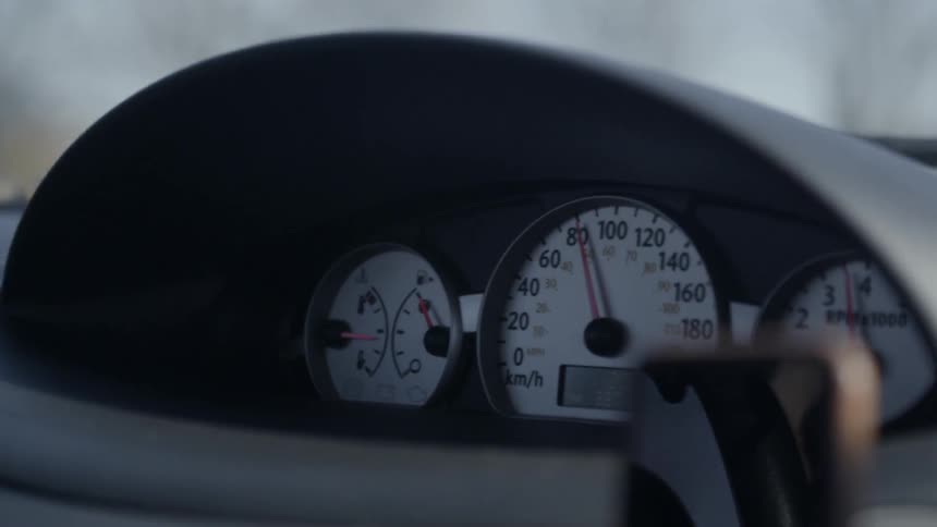 The speedometer on a car's dashboard as the car is driving