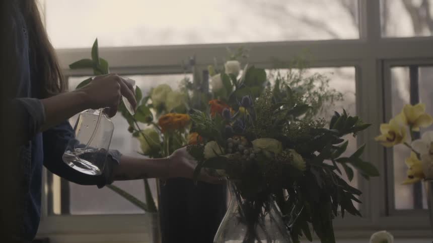A woman sprays a planet with a spray bottle