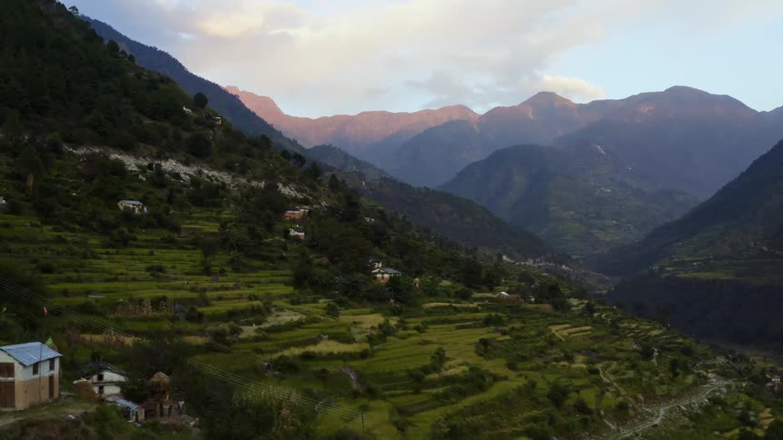 Buildings on a verdant mountain slope on a sunny day