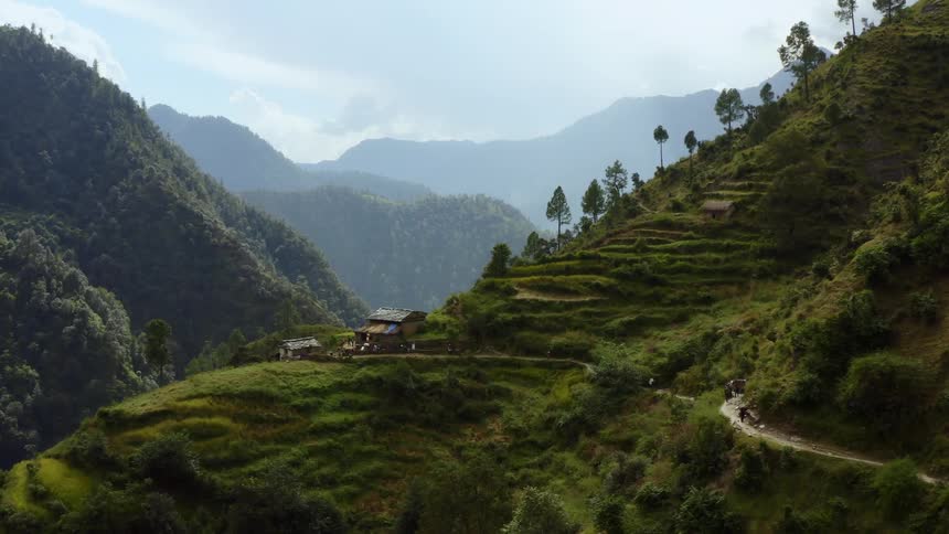Flying through a canyon with a house on a terraced hill