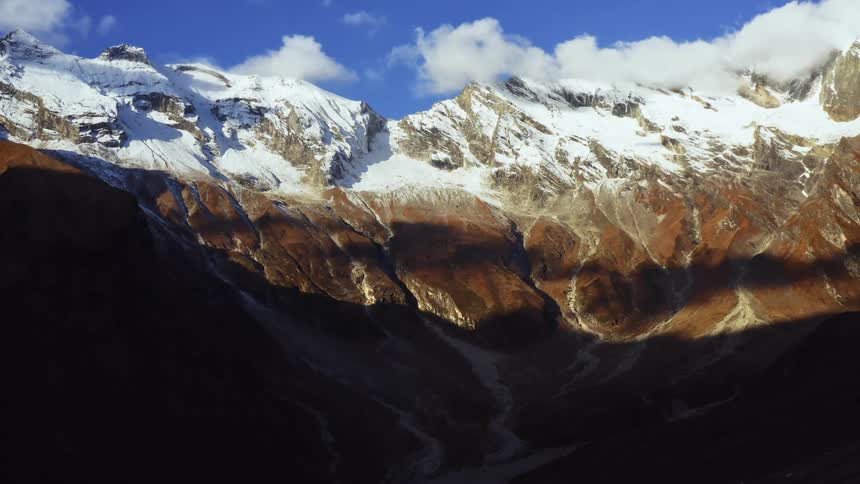 The sun is shining above the mountains