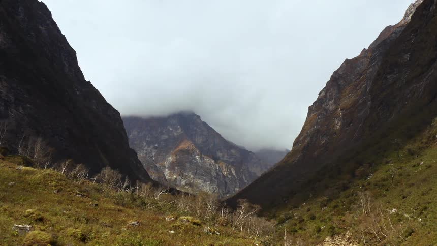 Clouds over a valley and mountain range