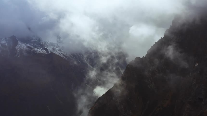 Flying through a cloud and snow high in the mountains