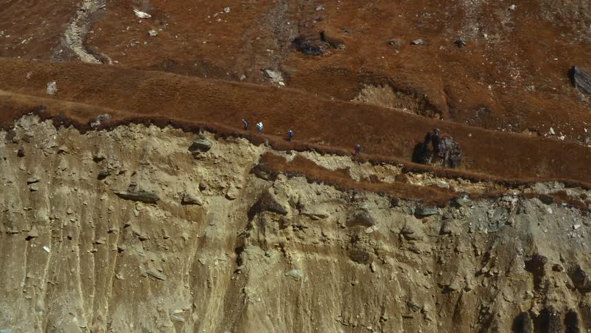 People are hiking along the cliff
