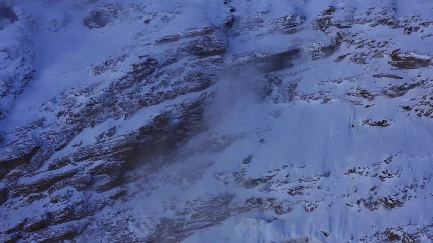 A snow covered mountainside in the wilderness