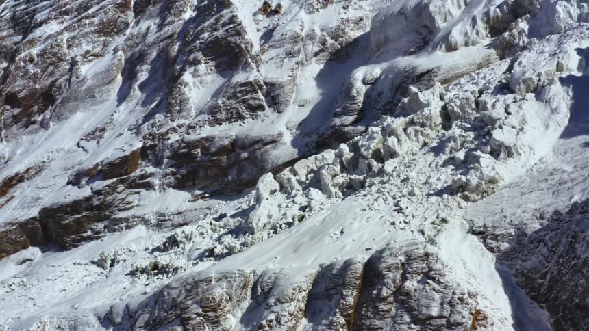Large ice formations on the slope of a snowy mountain