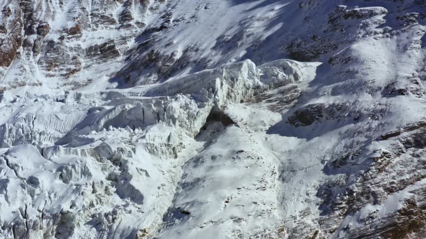 A snow covered mountainside in the wilderness