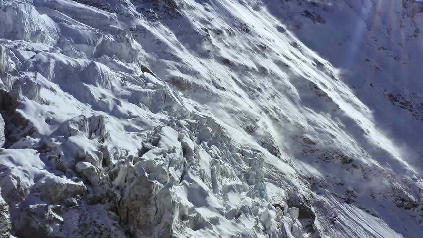 A jagged mountain slope covered in frost and compacted snow