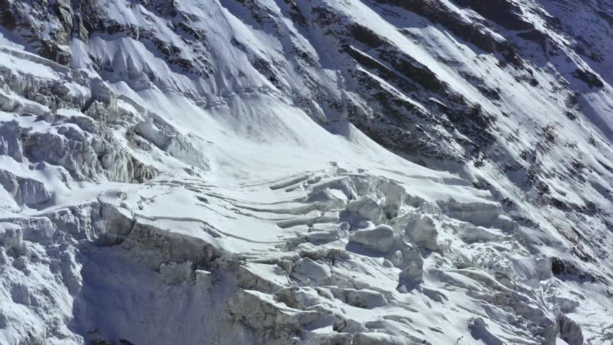 Compacted snow and ice on a mountain slope on a sunny day
