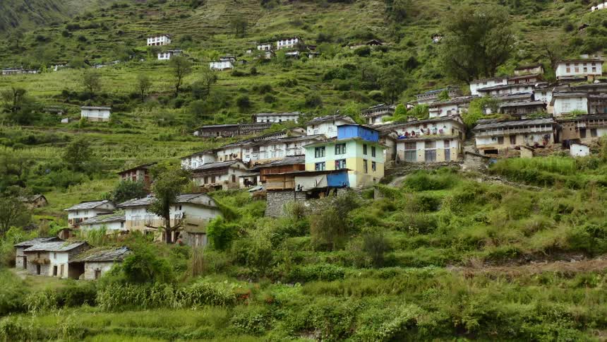 Aerial view of buildings in a village built on the side of a hill