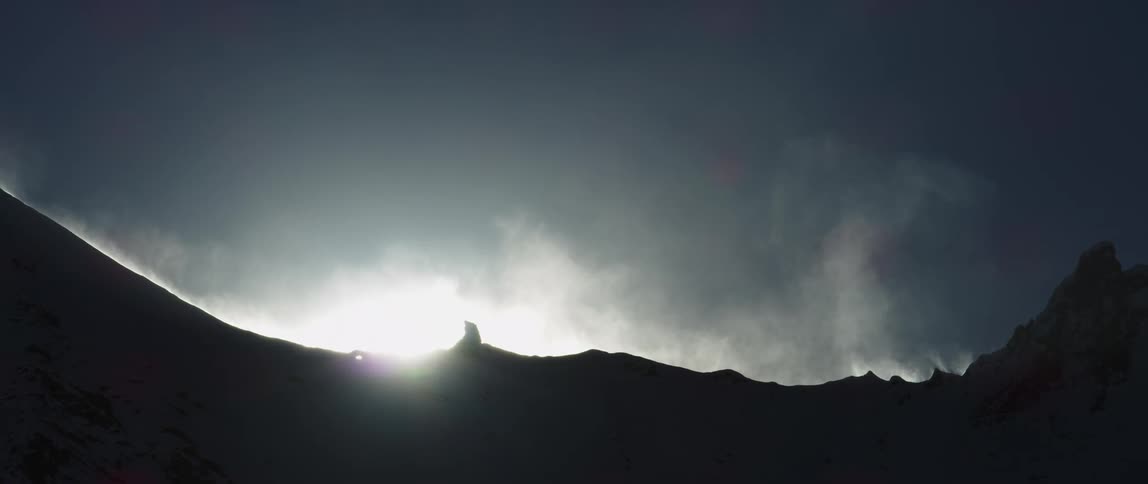 A sunny mountain top with steam rising up