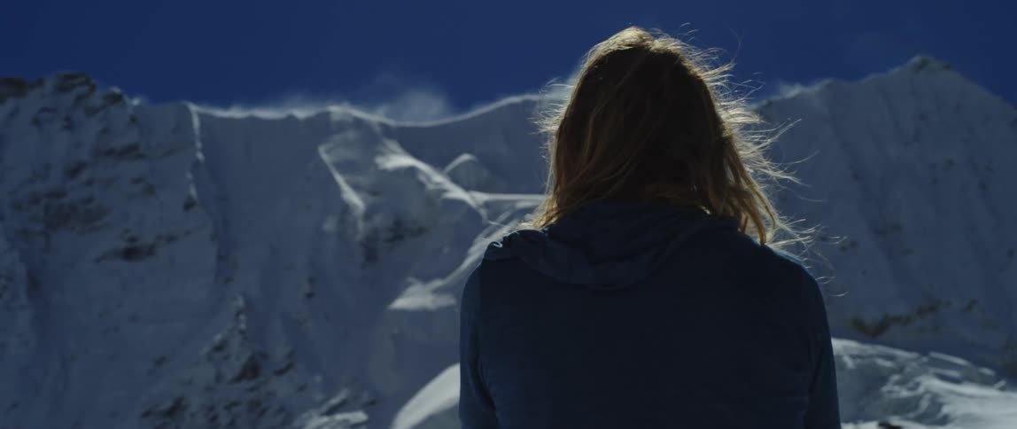 A woman is standing in an arctic area