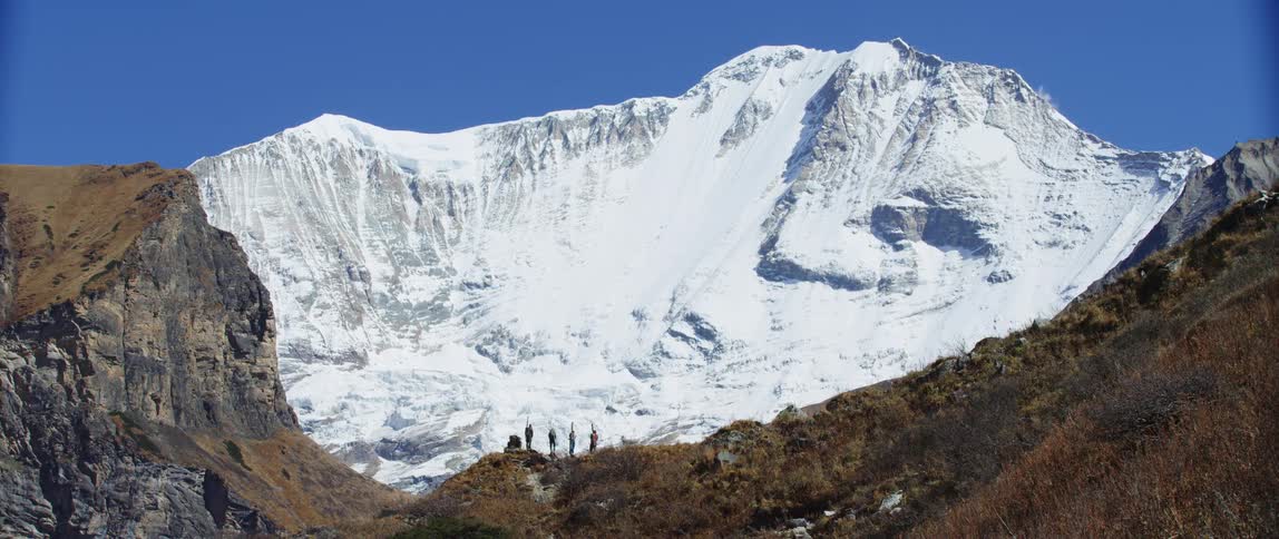 Hikers standing on a mountain slope on a winter day