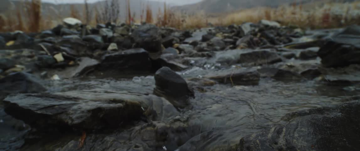 Rain falling on a river bed