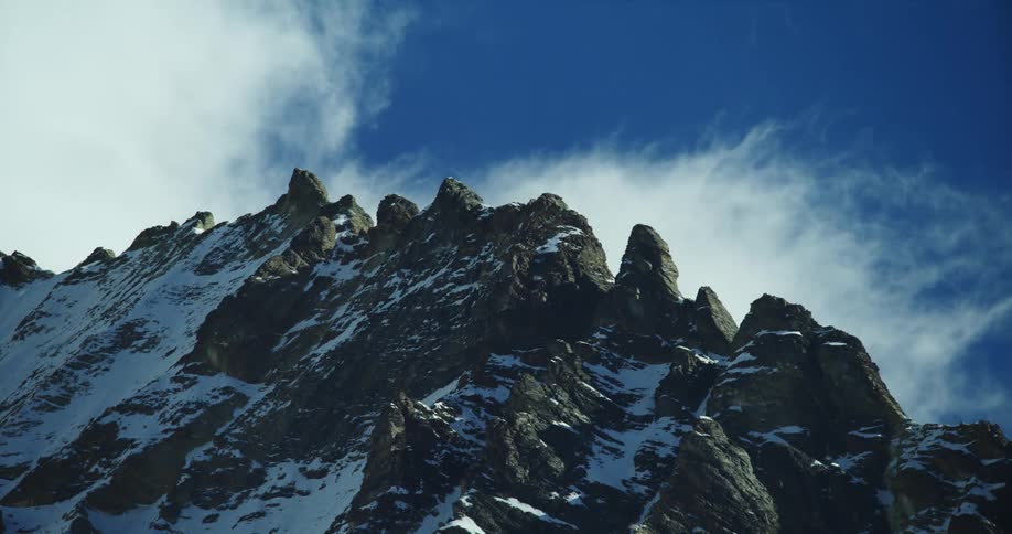 Snow is covering the mountains during the day