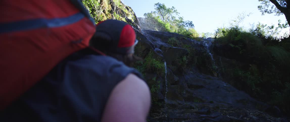 A man on a hiking trail looking into the distance