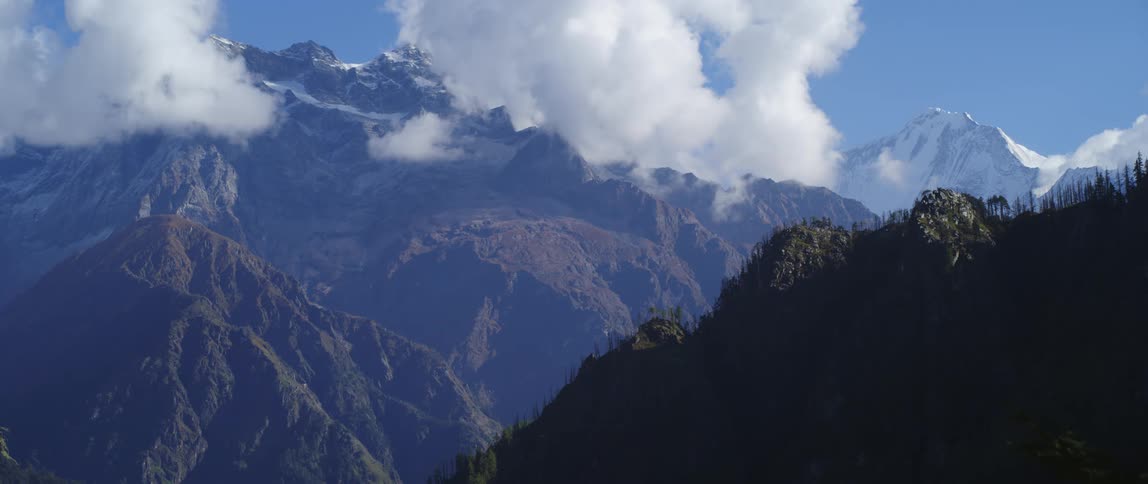The clouds sit on the tall mountain